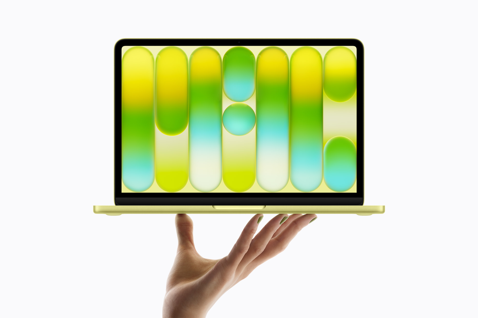 MacBook Neo in citrus held open on one hand